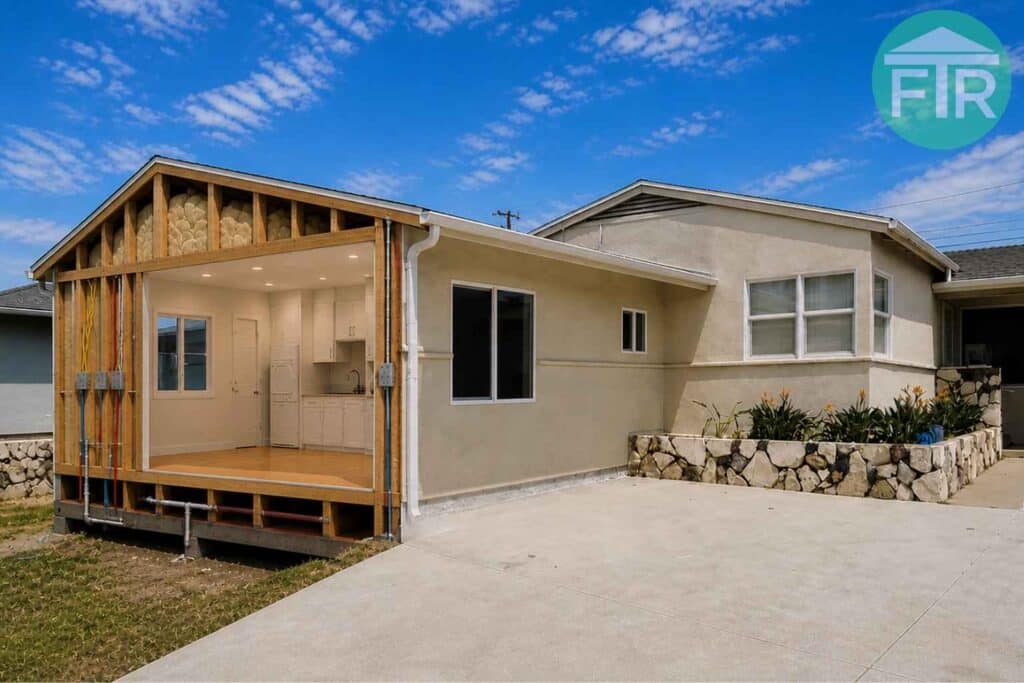 Garage-to-ADU conversion in Gardena featuring wood framing, white shaker cabinets, and recessed lighting by FTR Inc.